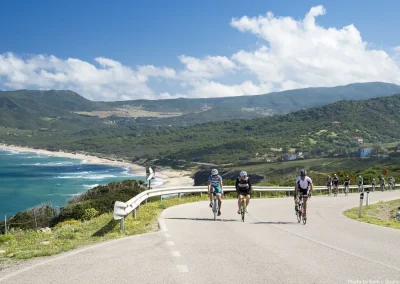 cyclists riding near sea